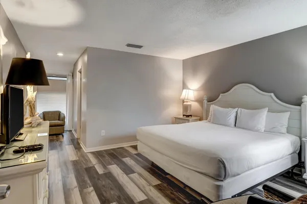 a room with a bed and a television