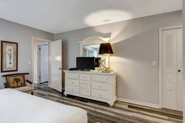 a bedroom with a bed a lamp and a fireplace