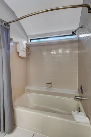 a bathroom with a granite countertop sink double and mirror