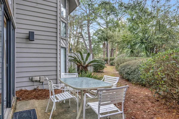 a view of a patio with table and chairs and potted plants