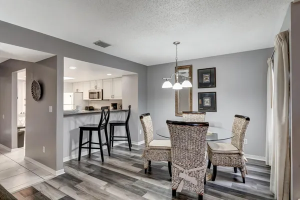 a view of a dining room with furniture and wooden floor