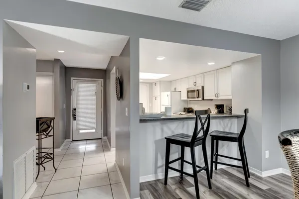 a kitchen with white cabinets and white appliances