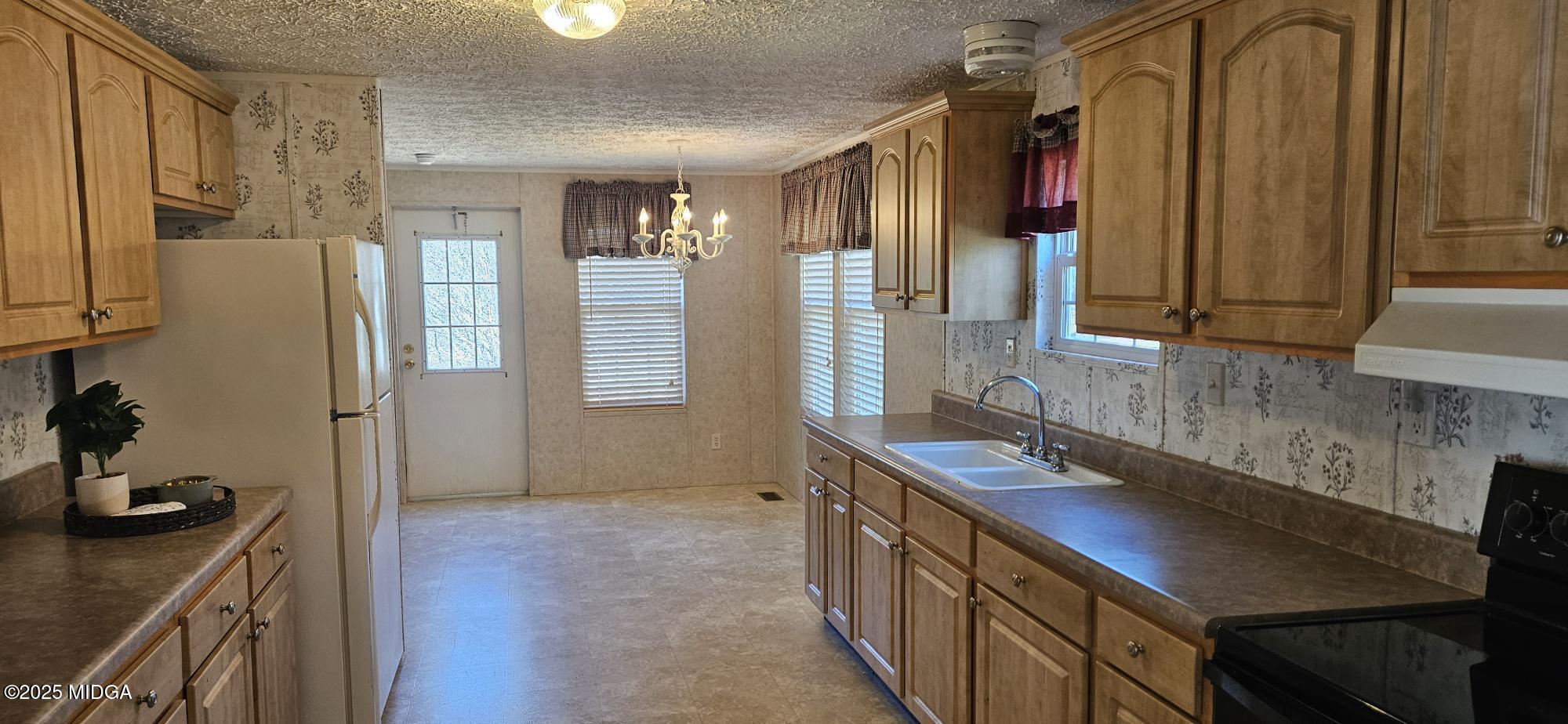 121 5 Points Road Gray, GA 31032 - Photo 9 of 20 a kitchen with stainless steel appliances granite countertop a sink refrigerator and cabinets