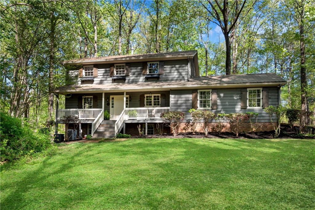 15355 Hopewell Road Alpharetta, GA 30004 - Photo 1 of 1 a view of a house with a yard
