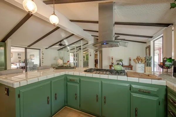 a kitchen with stainless steel appliances kitchen island granite countertop a sink and cabinets