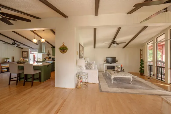 a view of a house with backyard and trees