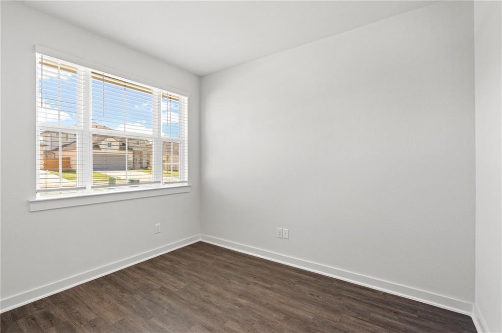 1012 Paddock Lane Georgetown, TX 78626 - Photo 7 of 15 Well-lit room with ample natural light and durable wood flooring.