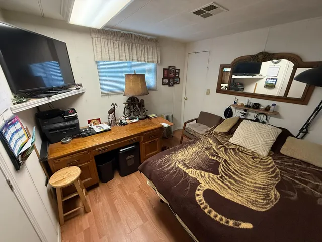 a bedroom with furniture and flat screen tv