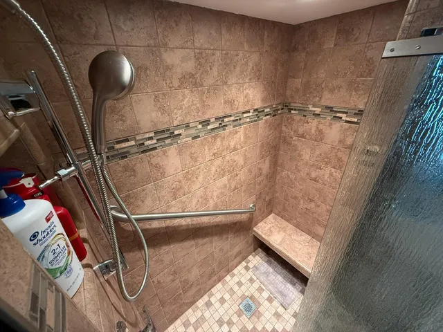a bathroom with a shower and a sink