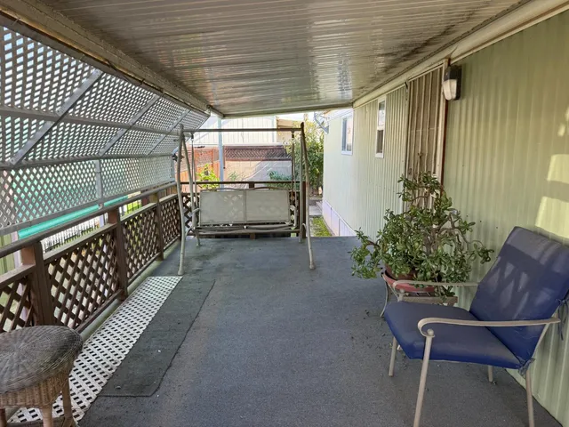 a view of a backyard with sitting area