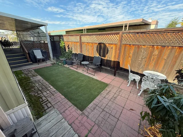 a view of a backyard with sitting area
