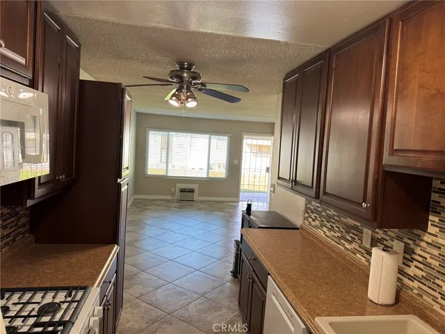 a spacious bathroom with a granite countertop sink a mirror and a bathtub