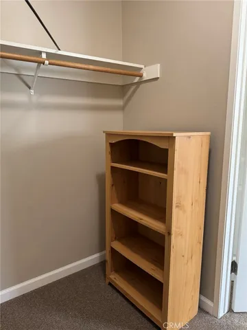 a view of walk in closet with empty racks