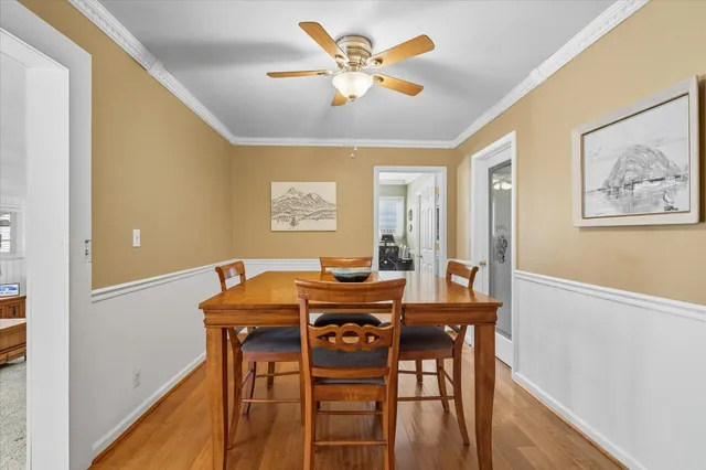 a view of a dining room with furniture and wooden floor