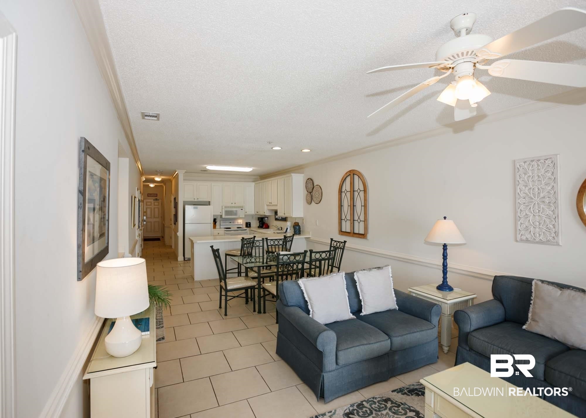 28910 Perdido Beach Boulevard, Unit 4B Orange Beach, AL 36561 - Photo 17 of 48 Living room with light tile patterned flooring, a textured ceiling, visible vents, ceiling fan, and ornamental molding