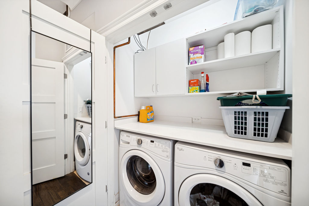 3044 North Racine Avenue, Unit 3 Chicago, IL 60657 - Photo 18 of 29 a view of washer and dryer with wooden cabinets