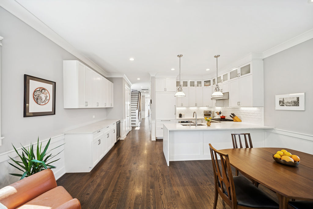 3044 North Racine Avenue, Unit 3 Chicago, IL 60657 - Photo 7 of 29 a kitchen with a wooden floor and white cabinets