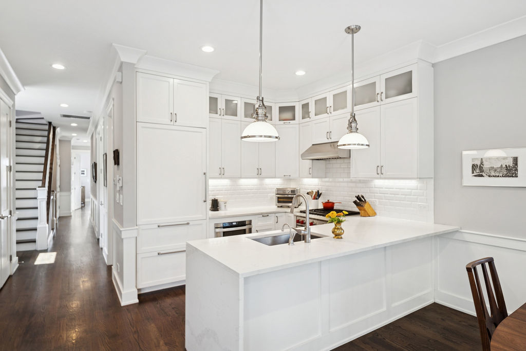 3044 North Racine Avenue, Unit 3 Chicago, IL 60657 - Photo 8 of 29 a kitchen with white cabinets and white appliances