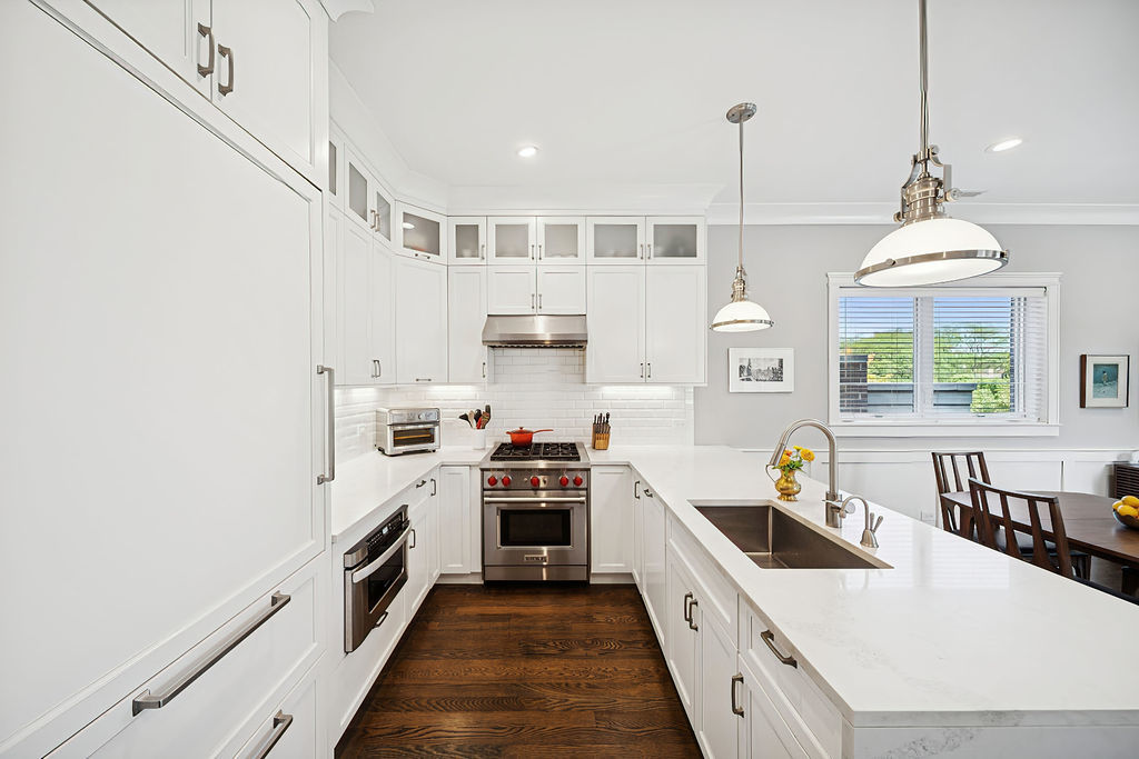 3044 North Racine Avenue, Unit 3 Chicago, IL 60657 - Photo 9 of 29 a kitchen with a stove a sink a window and cabinets