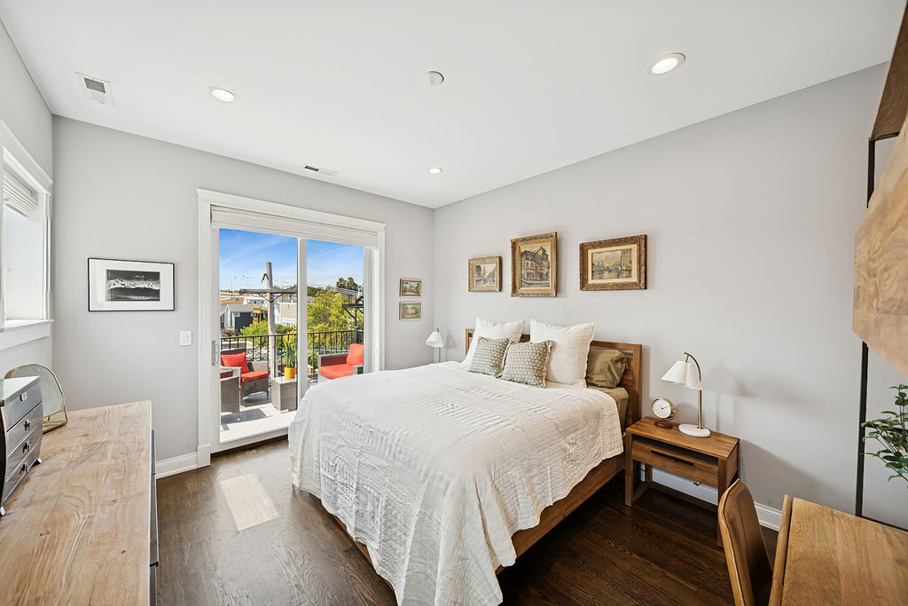 3044 North Racine Avenue, Unit 3 Chicago, IL 60657 - Photo 10 of 29 a bedroom with a bed garage and a window