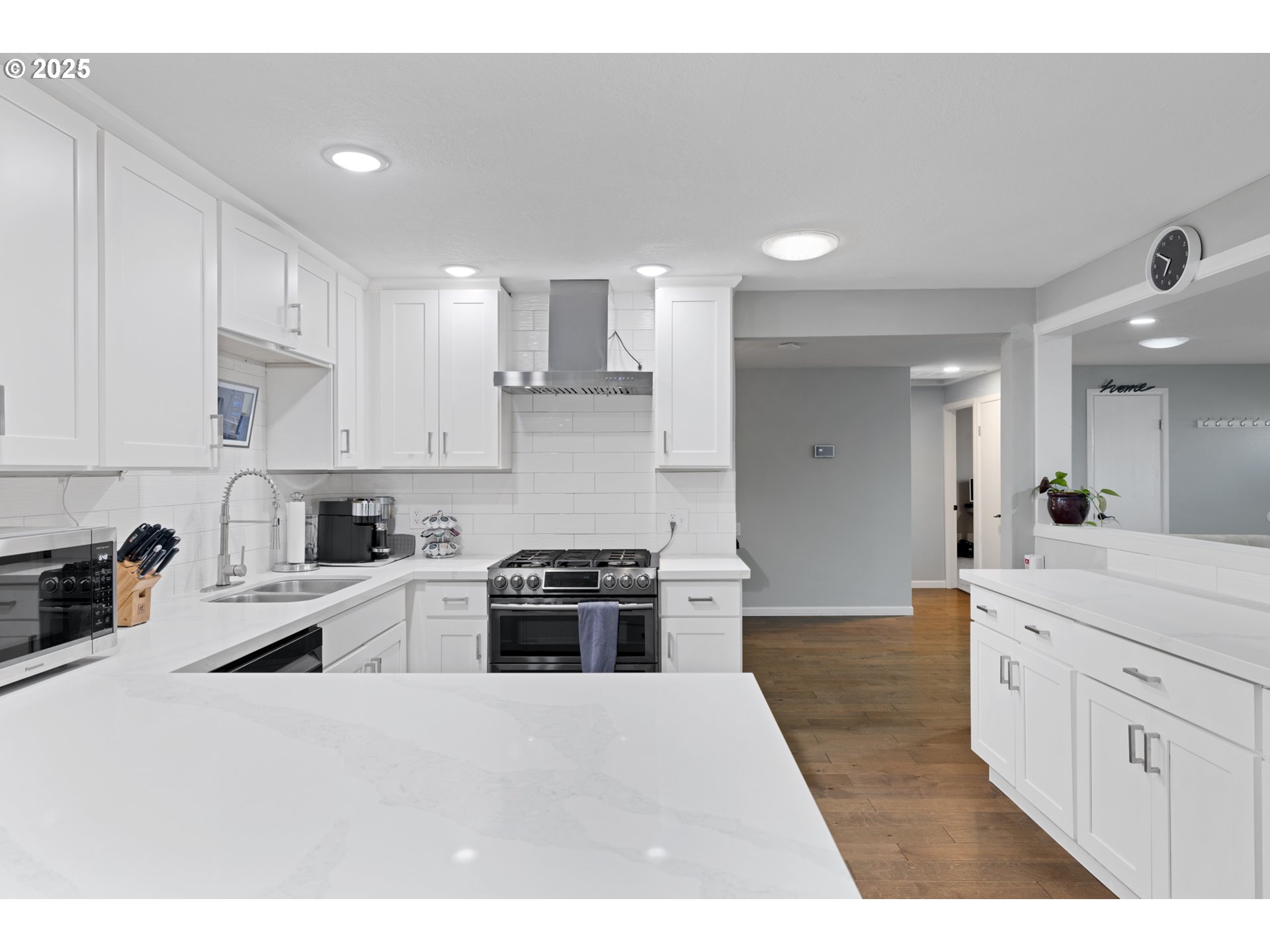 14435 Southwest Yearling Way Beaverton, OR 97008 - Photo 12 of 47 a large kitchen with stainless steel appliances granite countertop a stove a sink a refrigerator and white cabinets