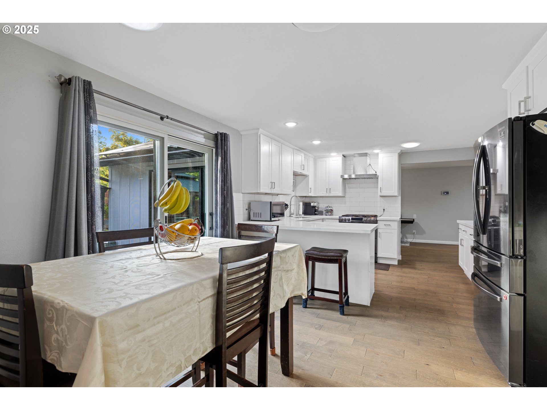 14435 Southwest Yearling Way Beaverton, OR 97008 - Photo 15 of 47 a kitchen with refrigerator cabinets and a table