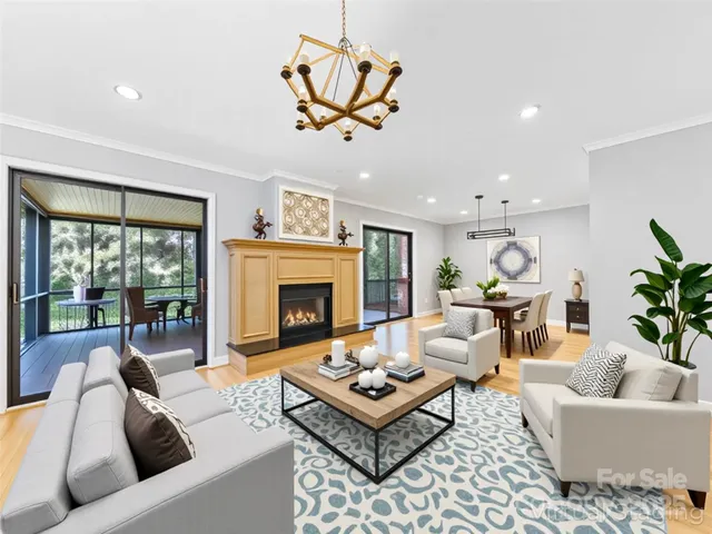 a living room with furniture a fireplace and a table