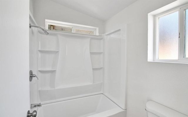 a close up of a bathtub with a shower