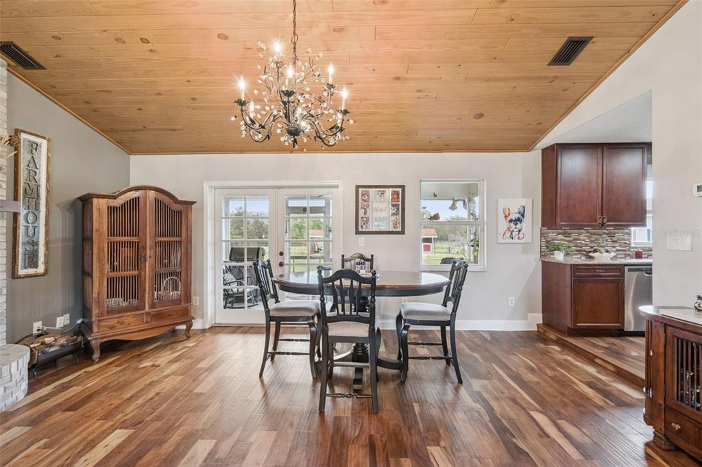 1330 Lake Mills Road Chuluota, FL 32766 - Photo 12 of 59 a view of a dining room with furniture window and wooden floor