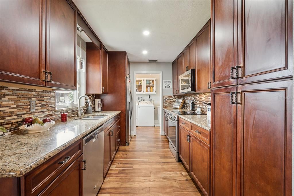 1330 Lake Mills Road Chuluota, FL 32766 - Photo 17 of 59 a view of a kitchen with stainless steel appliances granite countertop lots of counter top space
