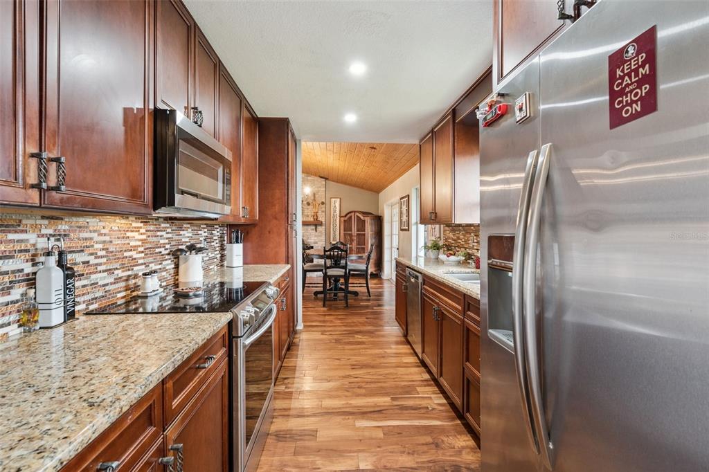1330 Lake Mills Road Chuluota, FL 32766 - Photo 18 of 59 a kitchen with stainless steel appliances granite countertop lots of counter top space