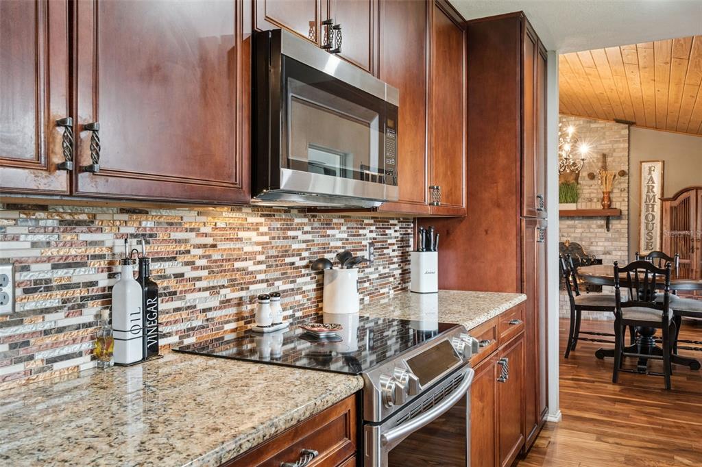 1330 Lake Mills Road Chuluota, FL 32766 - Photo 20 of 59 a kitchen with granite countertop a sink and a stove