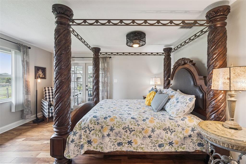 1330 Lake Mills Road Chuluota, FL 32766 - Photo 22 of 59 a bedroom with a bed and wooden floor