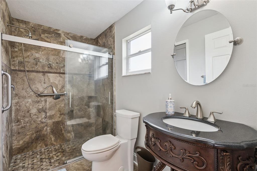 1330 Lake Mills Road Chuluota, FL 32766 - Photo 27 of 59 a bathroom with a granite countertop sink toilet and a mirror
