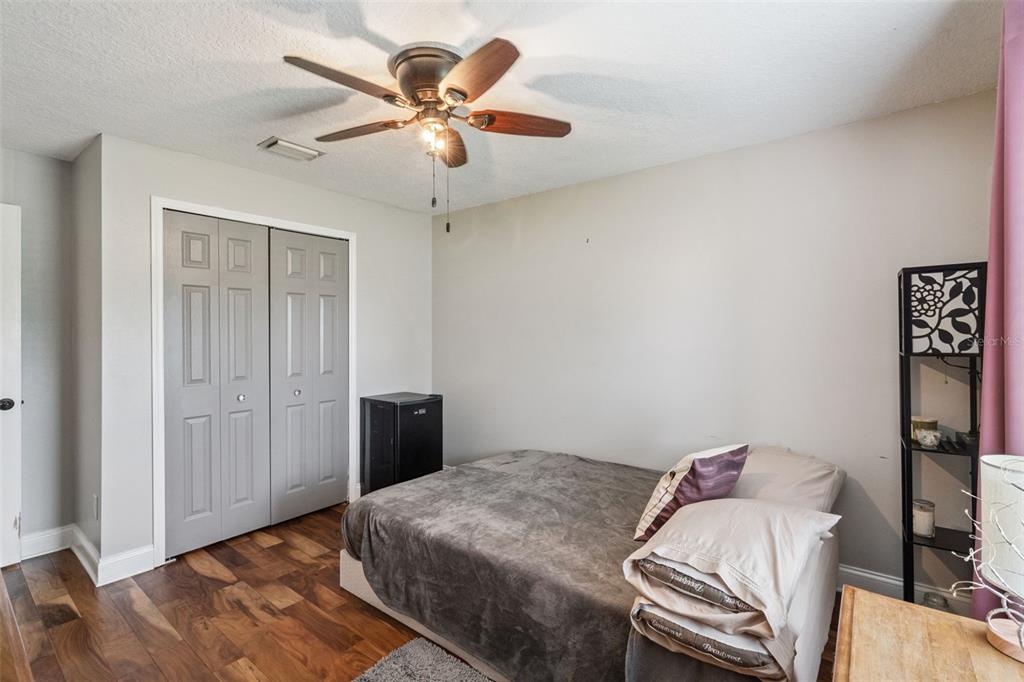 1330 Lake Mills Road Chuluota, FL 32766 - Photo 30 of 59 a bedroom with a bed and a chandelier