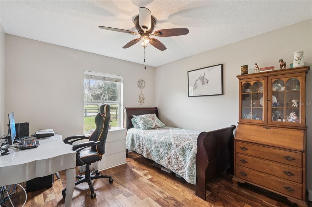 1330 Lake Mills Road Chuluota, FL 32766 - Photo 31 of 59 a bedroom with a bed and a desk