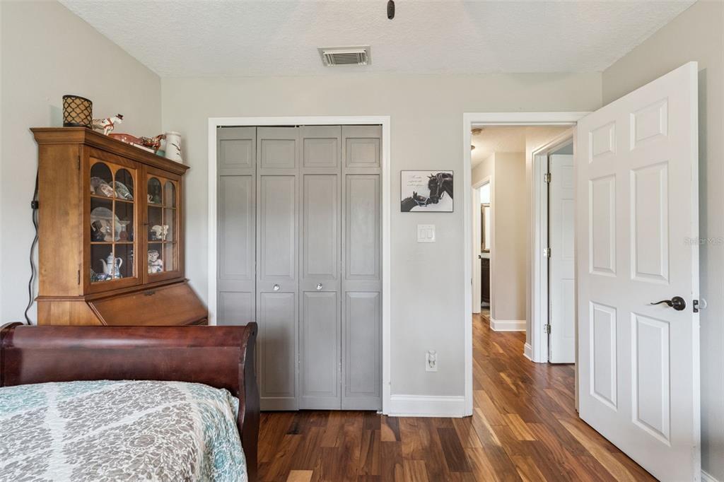 1330 Lake Mills Road Chuluota, FL 32766 - Photo 32 of 59 a bedroom with a bed and wooden floor