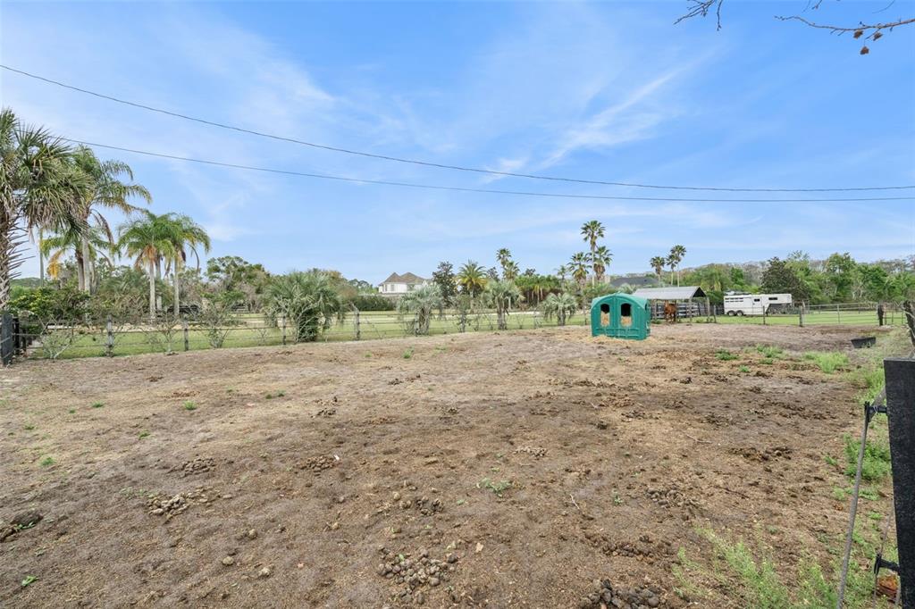 1330 Lake Mills Road Chuluota, FL 32766 - Photo 37 of 59 a view of a field with large trees