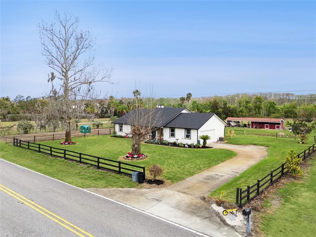 1330 Lake Mills Road Chuluota, FL 32766 - Photo 42 of 59 an aerial view of a house with a yard and lake view