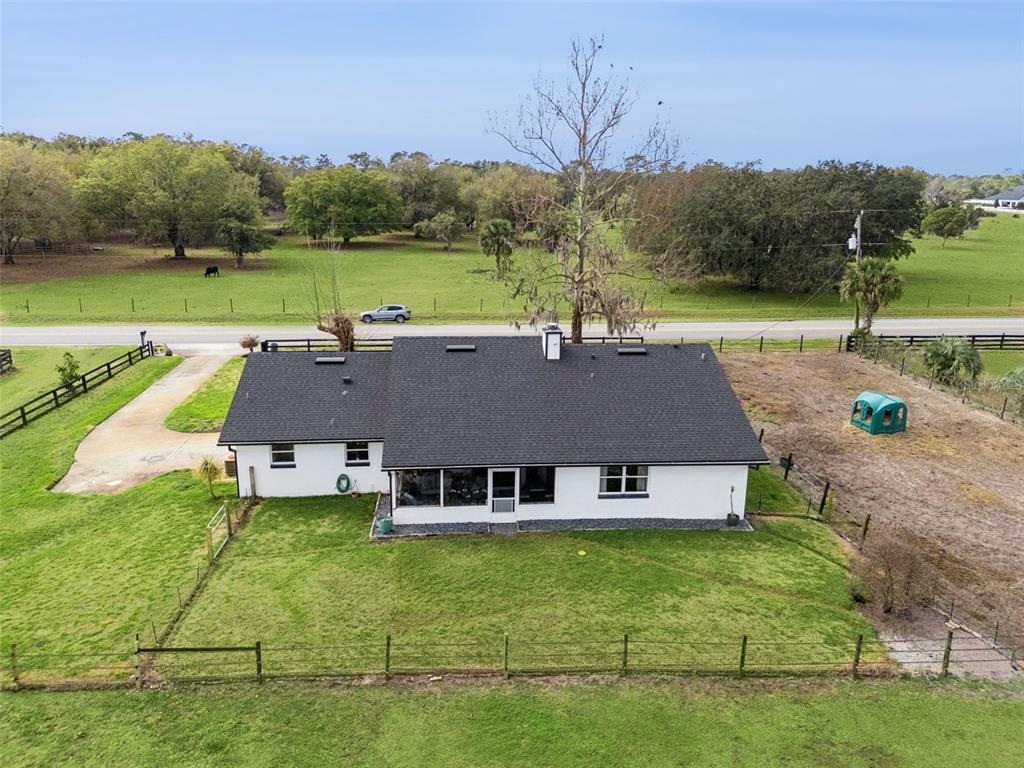 1330 Lake Mills Road Chuluota, FL 32766 - Photo 45 of 59 a aerial view of a house with garden space and a patio