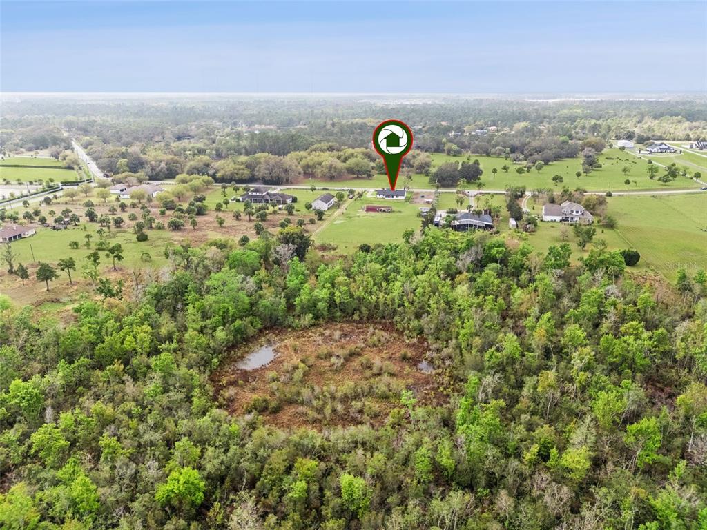 1330 Lake Mills Road Chuluota, FL 32766 - Photo 49 of 59 an aerial view of a forest with a forest