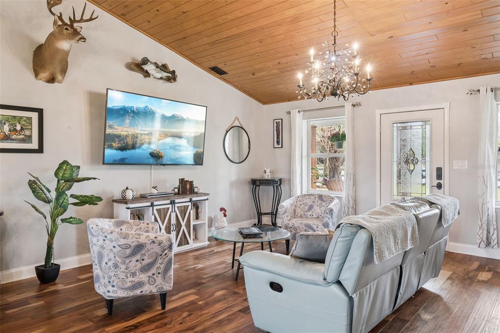 1330 Lake Mills Road Chuluota, FL 32766 - Photo 5 of 59 a living room with furniture and a chandelier
