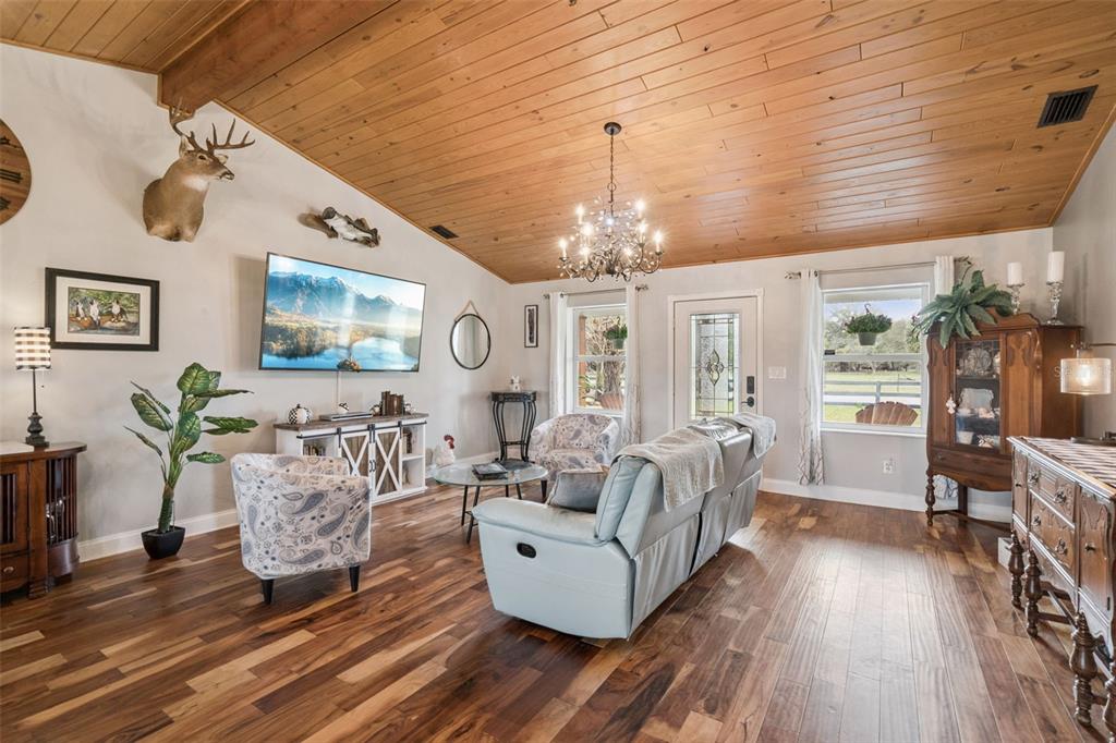 1330 Lake Mills Road Chuluota, FL 32766 - Photo 6 of 59 a living room with furniture and a chandelier