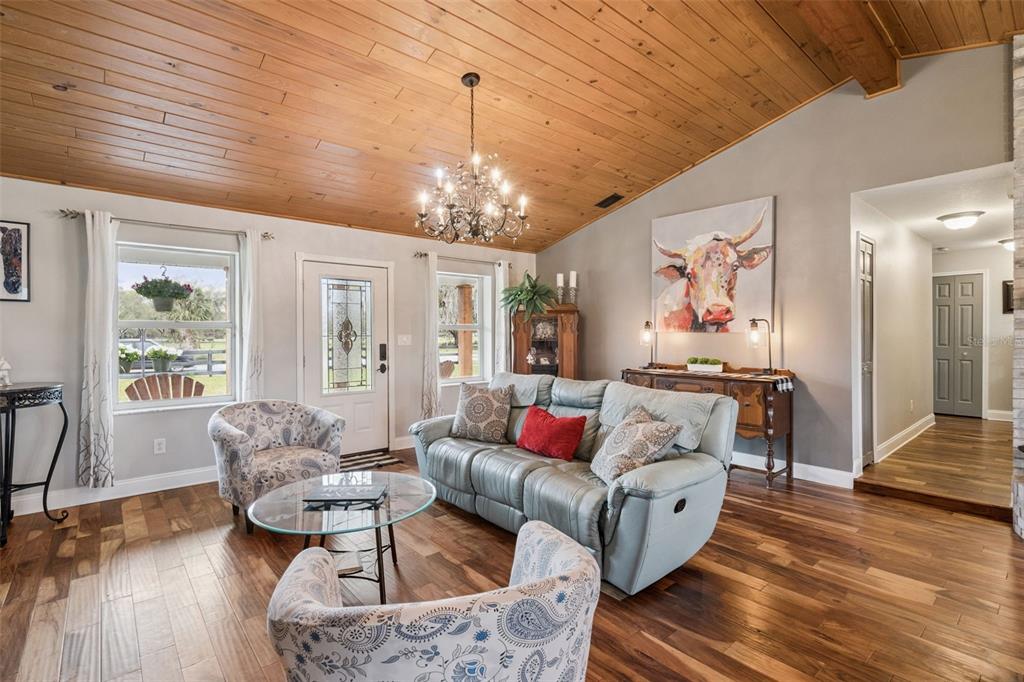 1330 Lake Mills Road Chuluota, FL 32766 - Photo 7 of 59 a living room with furniture and a chandelier