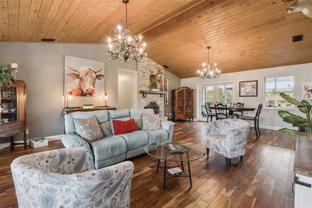 1330 Lake Mills Road Chuluota, FL 32766 - Photo 8 of 59 a living room with furniture and a chandelier