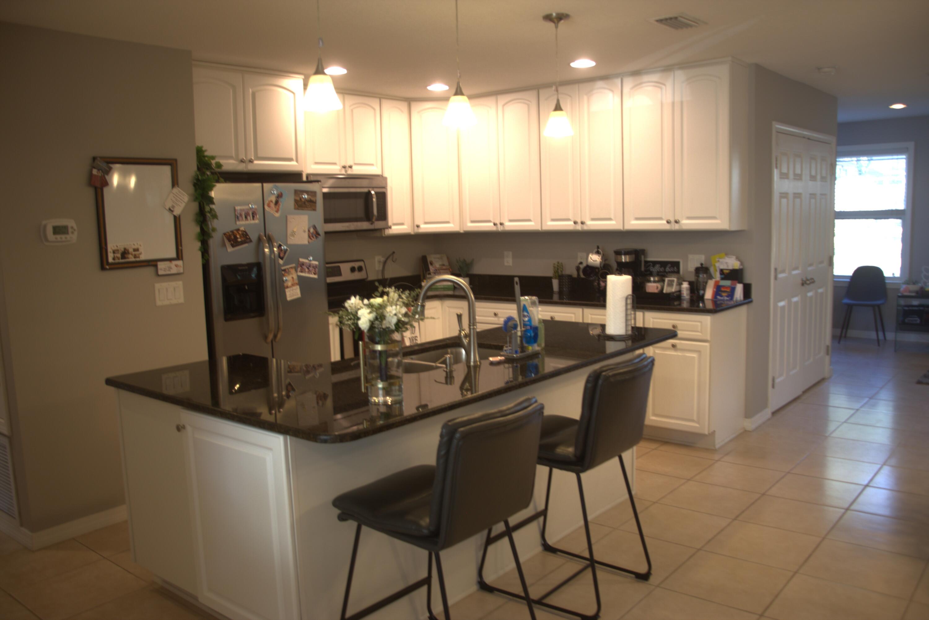 75 7th Avenue Shalimar, FL 32579 - Photo 12 of 42 a kitchen with stainless steel appliances granite countertop a sink and a refrigerator