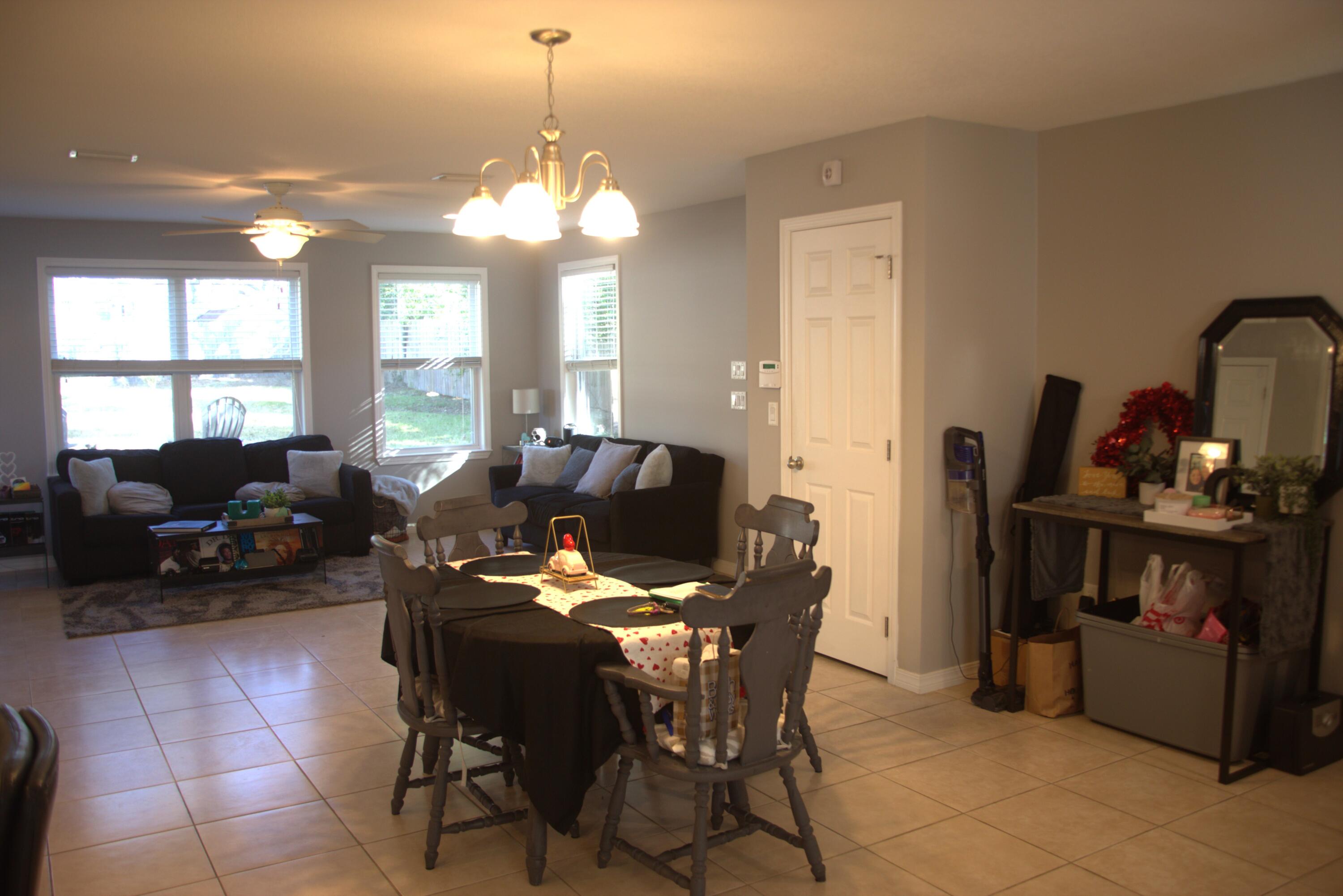75 7th Avenue Shalimar, FL 32579 - Photo 15 of 42 a living room with furniture a chandelier and a flat screen tv