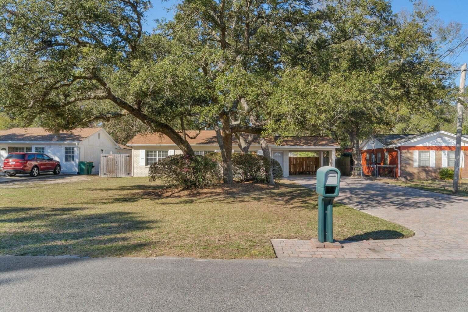 75 7th Avenue Shalimar, FL 32579 - Photo 2 of 42 a front view of a house with a yard and garage