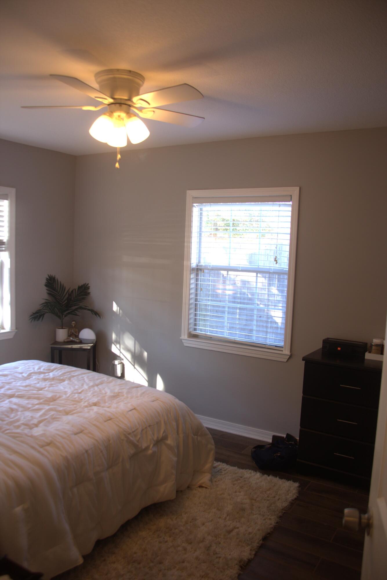 75 7th Avenue Shalimar, FL 32579 - Photo 22 of 42 a bedroom with a bed and a chandelier