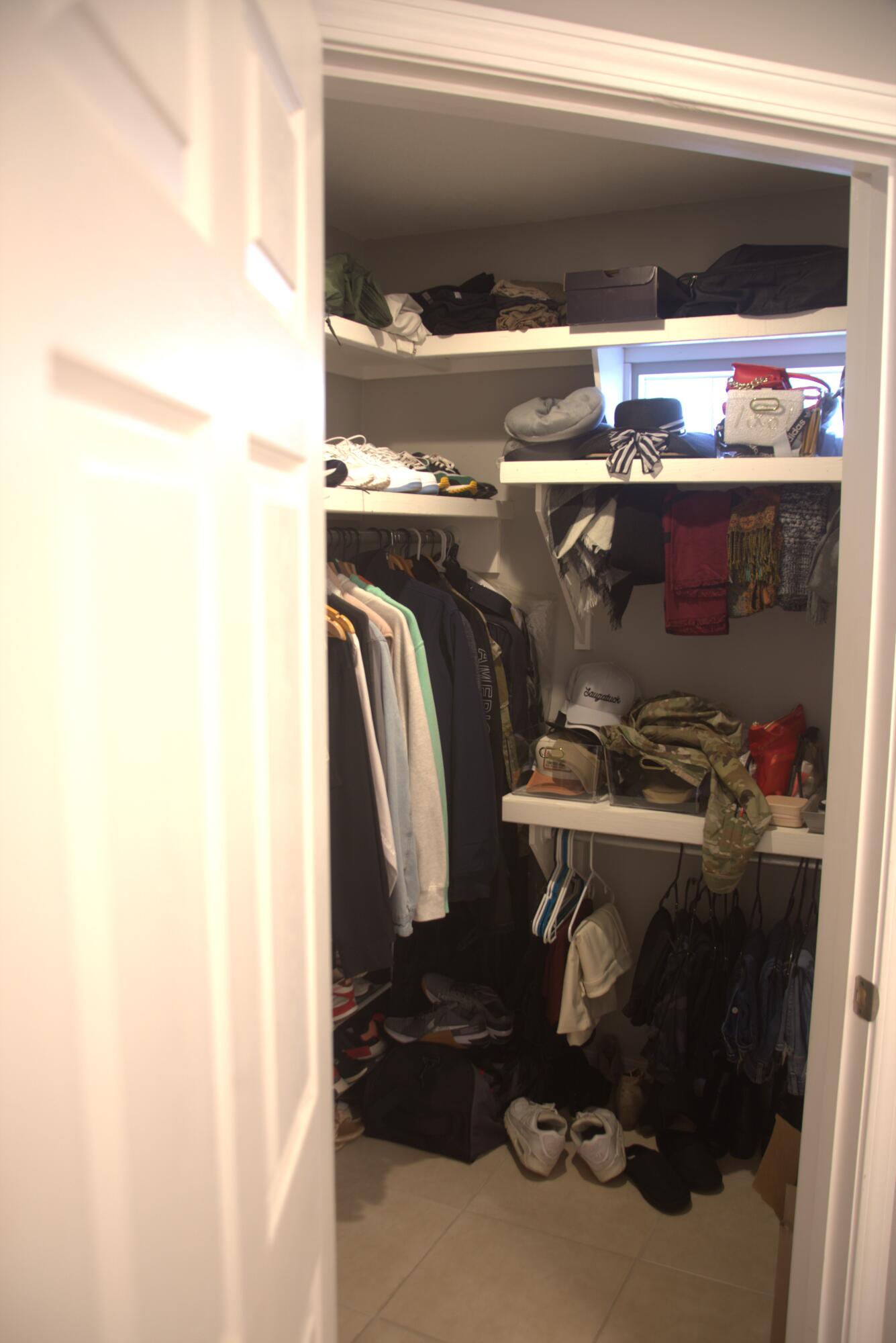75 7th Avenue Shalimar, FL 32579 - Photo 27 of 42 a view of walk in closet with clothes and shoes